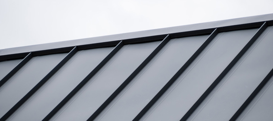 Metal roofing panels; cloudy sky.